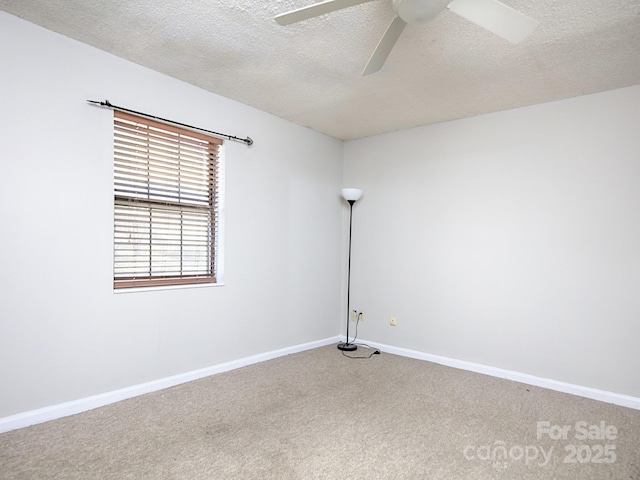 unfurnished room with ceiling fan, carpet floors, a textured ceiling, and baseboards