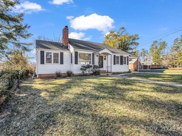 ranch-style house featuring a chimney and a front yard