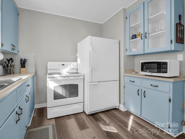 kitchen featuring light countertops, white appliances, glass insert cabinets, and blue cabinets