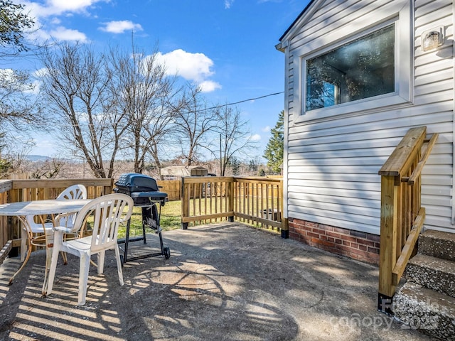 view of patio with a wooden deck, area for grilling, and outdoor dining space