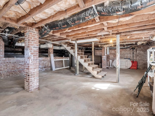 unfinished below grade area with brick wall and stairway