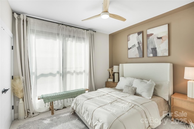 bedroom with light carpet and ceiling fan