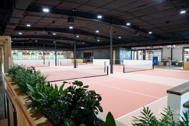 view of tennis court featuring fence