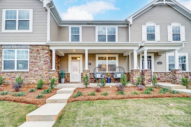 view of front of house with a porch and a front lawn