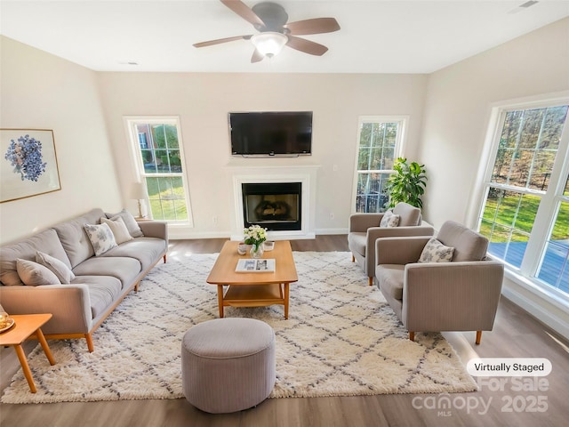 living room featuring ceiling fan and light hardwood / wood-style flooring