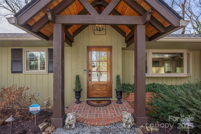 view of exterior entry featuring board and batten siding