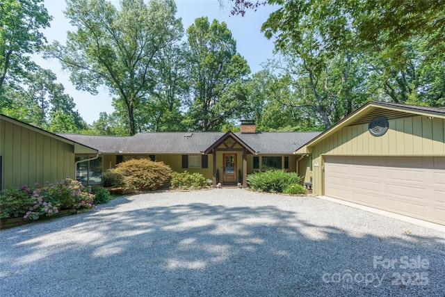 100 Stone Circle Dr, Tryon, NC 28782 - single story home with gravel driveway, a chimney, and a garage