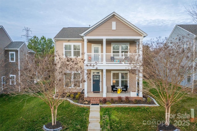 view of front of home with a balcony, a front lawn, and a porch