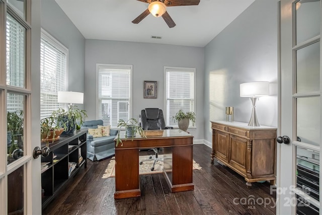 home office featuring ceiling fan, dark wood-type flooring, visible vents, and baseboards