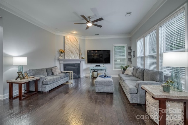 living area featuring dark wood-style flooring, a fireplace, visible vents, baseboards, and ornamental molding