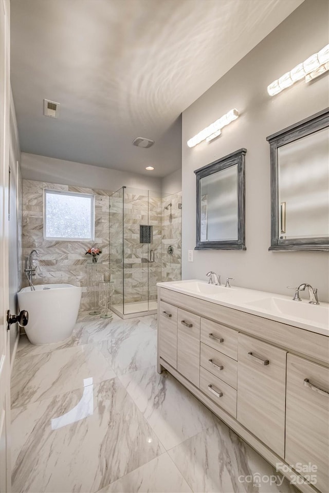 bathroom with a sink, visible vents, marble finish floor, a shower stall, and double vanity