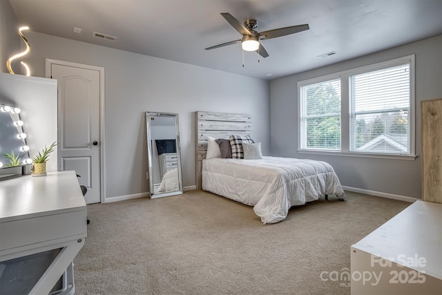 bedroom with a ceiling fan, visible vents, baseboards, and carpet flooring