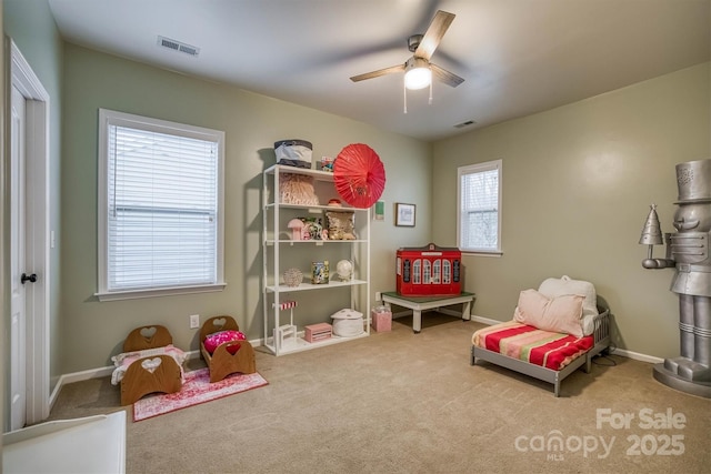 rec room featuring ceiling fan, carpet flooring, visible vents, and baseboards