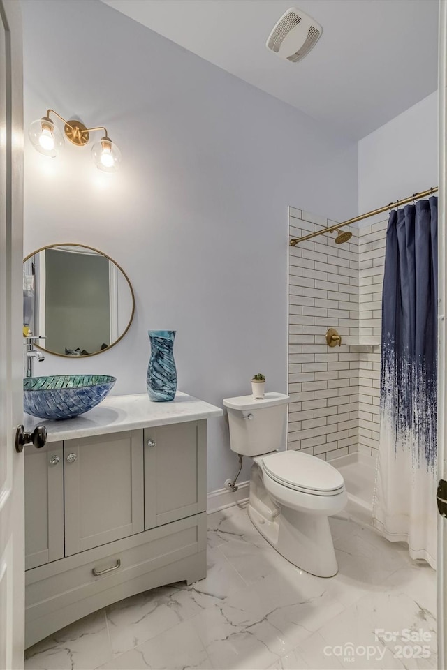 bathroom featuring marble finish floor, a shower stall, visible vents, and vanity