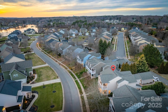 aerial view at dusk featuring a residential view