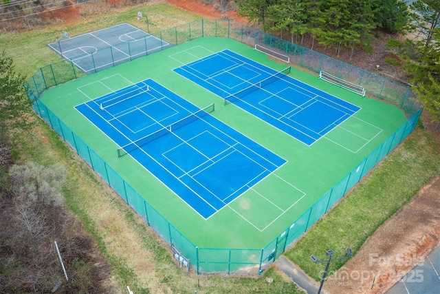 view of tennis court with fence