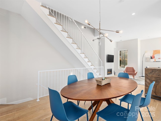 dining area featuring a notable chandelier and light hardwood / wood-style floors