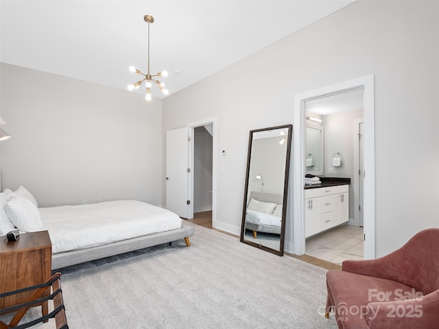 bedroom featuring connected bathroom and a notable chandelier