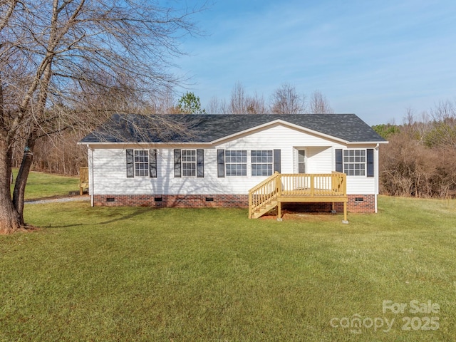 back of house featuring a wooden deck and a yard