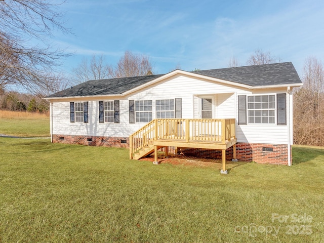 rear view of property featuring a yard and a deck