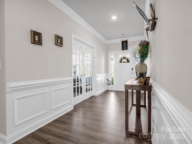 corridor with crown molding, dark wood-type flooring, and french doors