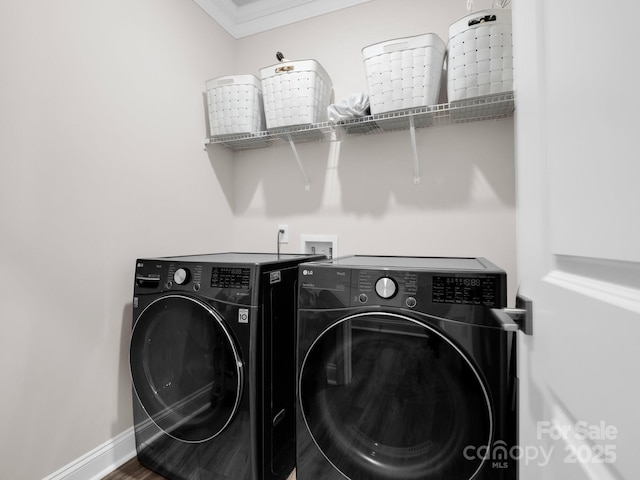 washroom with hardwood / wood-style floors, crown molding, and washing machine and dryer