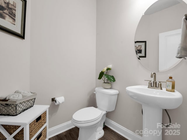 bathroom with sink, wood-type flooring, and toilet