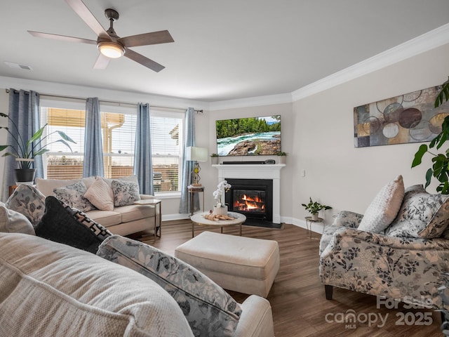 living room featuring dark hardwood / wood-style flooring, crown molding, and ceiling fan