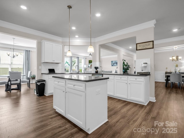 kitchen with white cabinets, decorative light fixtures, and a chandelier