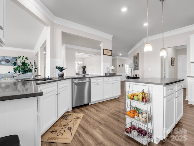 kitchen featuring sink, white cabinetry, light wood-type flooring, stainless steel dishwasher, and pendant lighting