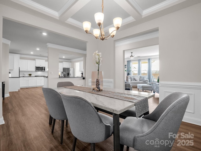 dining room featuring beamed ceiling, dark hardwood / wood-style floors, ceiling fan with notable chandelier, and crown molding