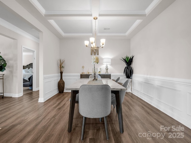 dining space featuring coffered ceiling, crown molding, dark hardwood / wood-style floors, a notable chandelier, and beam ceiling