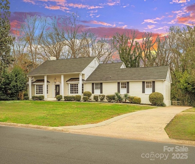 view of front of property with a chimney and a front lawn