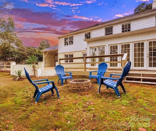 rear view of house featuring a fire pit, board and batten siding, and entry steps