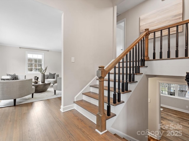 staircase with hardwood / wood-style flooring and baseboards