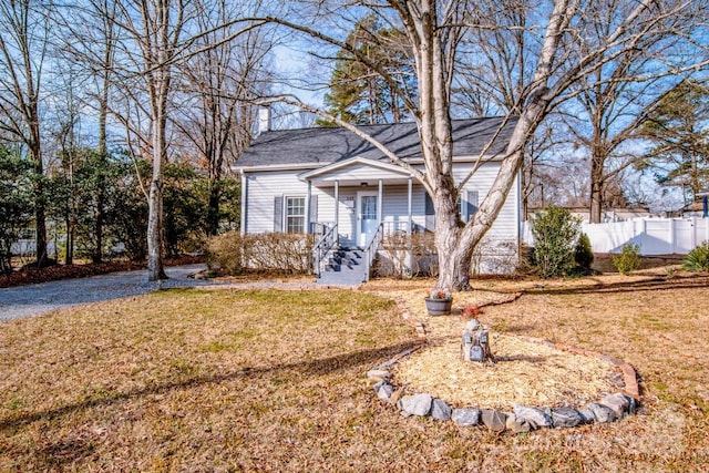 view of front of house with a porch and a front lawn