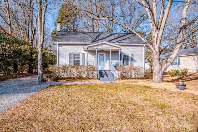 bungalow-style house featuring a front lawn