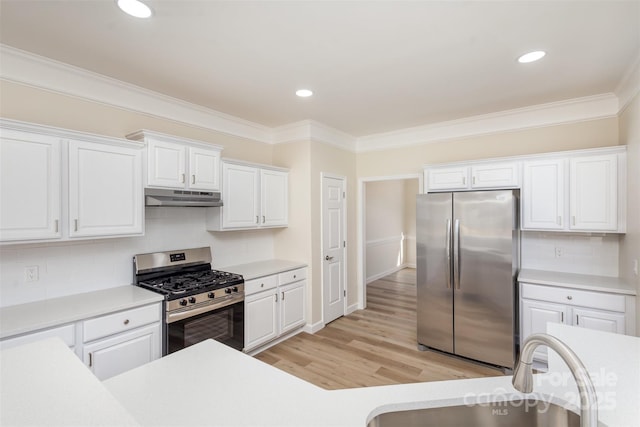 kitchen with sink, light hardwood / wood-style flooring, stainless steel appliances, ornamental molding, and white cabinets