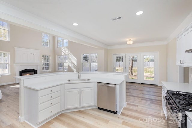 kitchen with white cabinetry, appliances with stainless steel finishes, sink, and ornamental molding