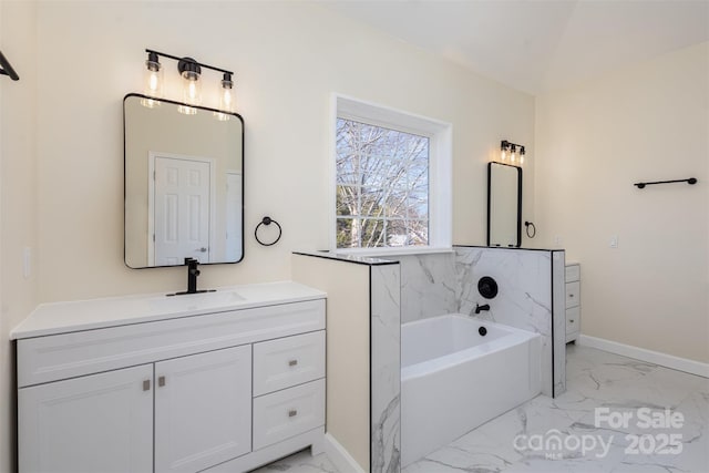 bathroom featuring vanity and a tub