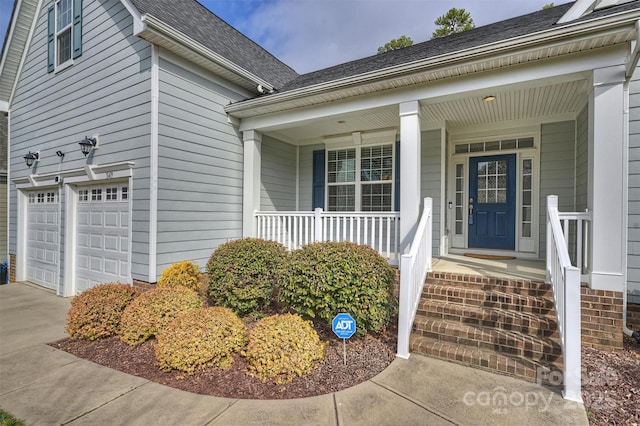 property entrance featuring a garage and covered porch