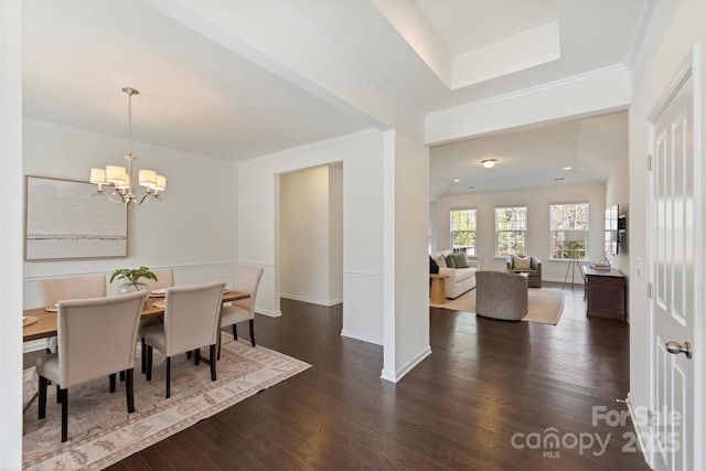 dining area featuring ornamental molding, dark hardwood / wood-style floors, and a chandelier