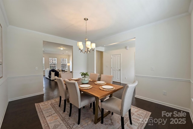 dining area with ornamental molding, dark hardwood / wood-style floors, and a notable chandelier