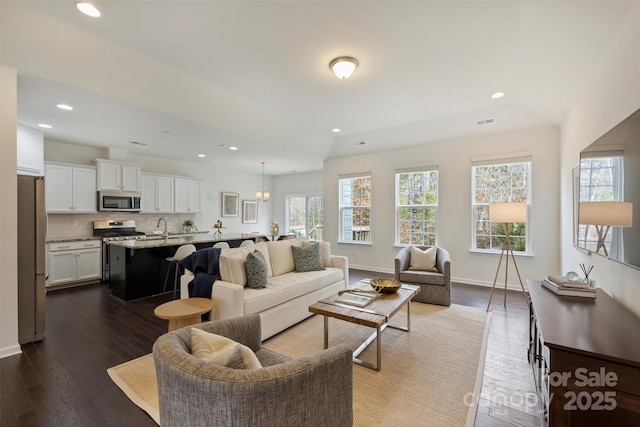 living room featuring dark hardwood / wood-style floors and sink