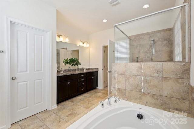 bathroom with vanity and independent shower and bath