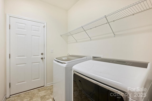 laundry area with washing machine and clothes dryer