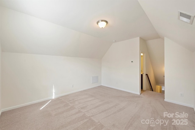 additional living space with vaulted ceiling and light colored carpet