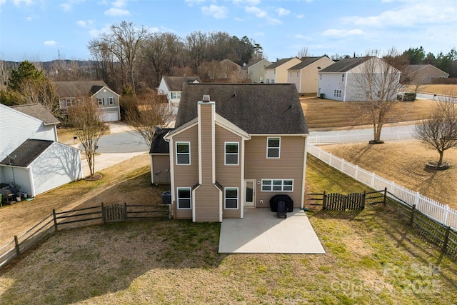 rear view of property with a yard and a patio