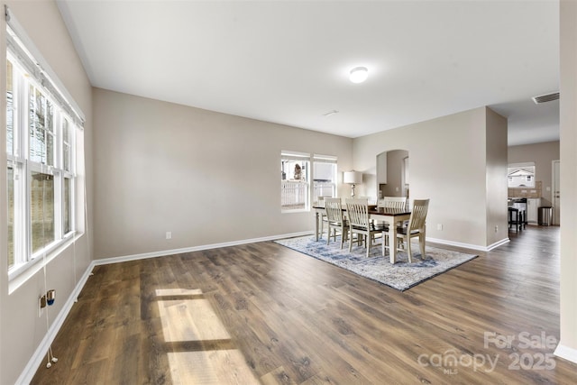 unfurnished dining area featuring dark wood-type flooring