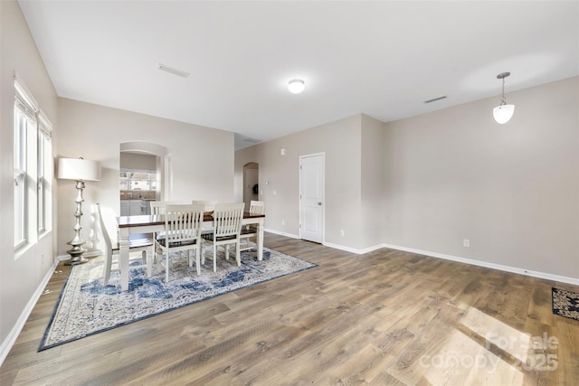 dining space with wood-type flooring